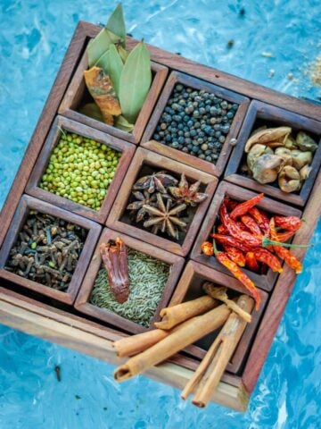 a masala box filled with dry spices used to make garam masala
