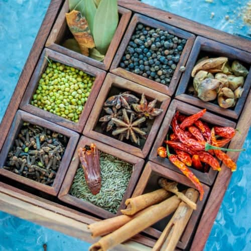 a masala box filled with dry spices used to make garam masala