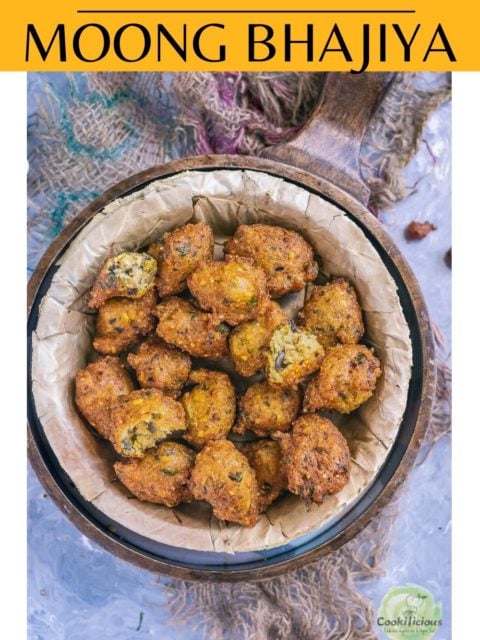Crispy Moong Dal Pakora served n a round bowl with green chutney on the side and text at the top