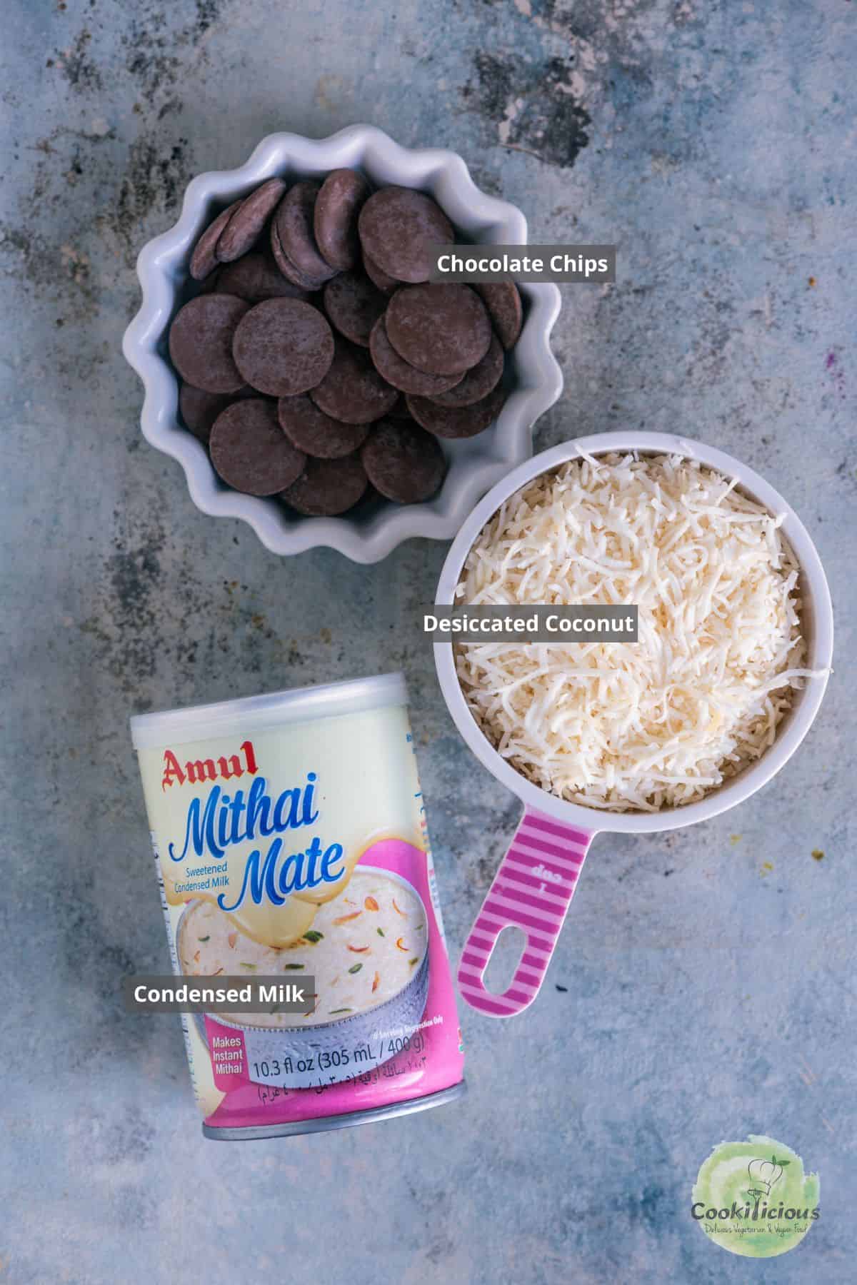 All the ingredients needed to make Chocolate Coconut Macaroons placed on a table with labels on them.