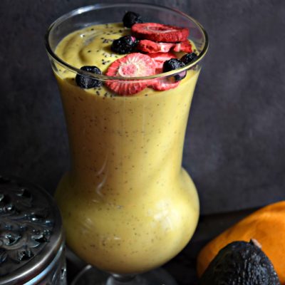 a tall glass filled with Vegan Mango Avocado Smoothie