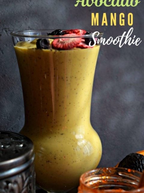 front view of a tall glass filled with Vegan Mango Avocado Smoothie with text at the top