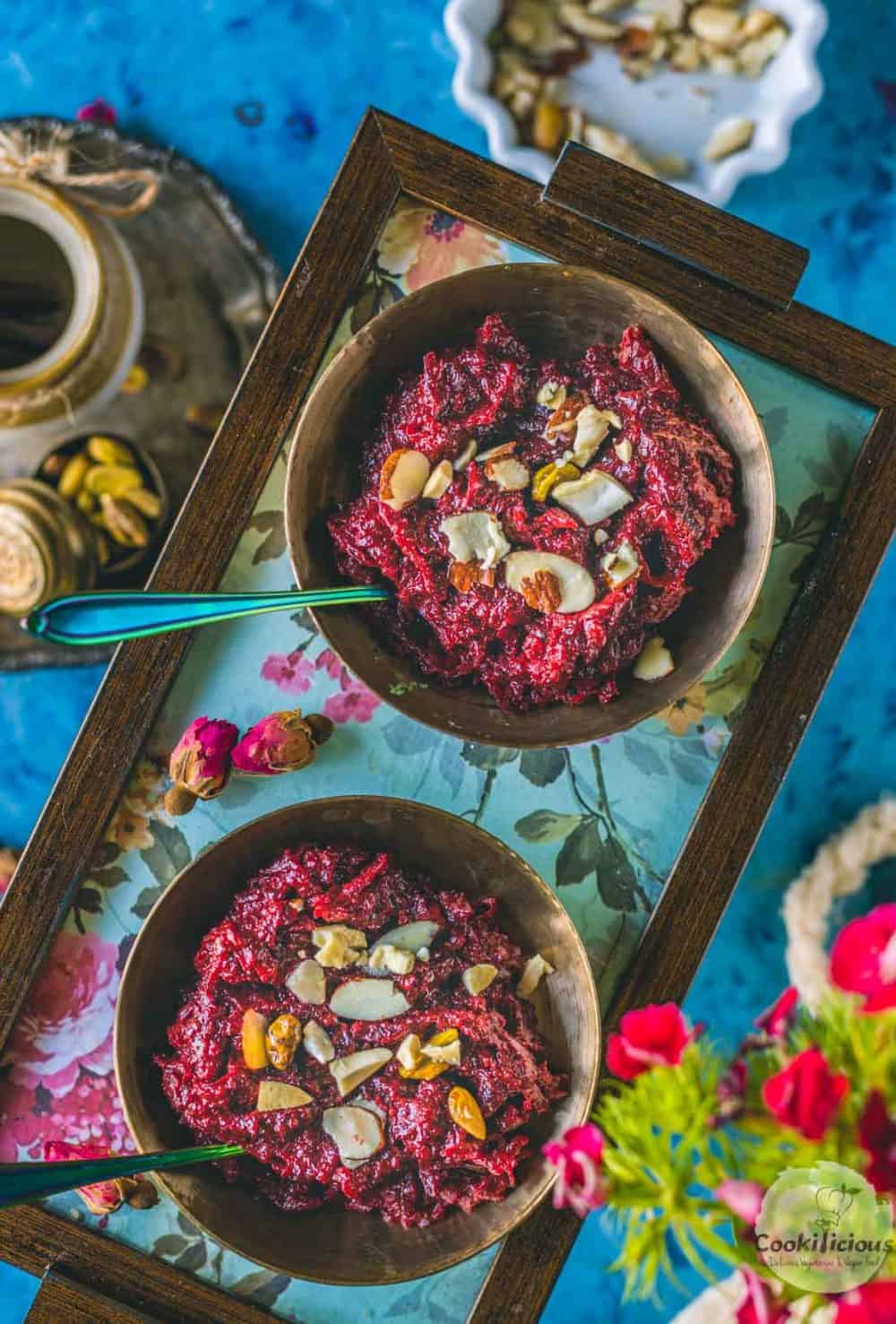 2 bowls of Beetroot Halwa served in a tray with spoons in them