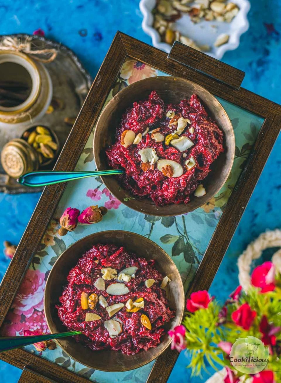 2 bowls of Beetroot Halwa served in a tray with spoons in them