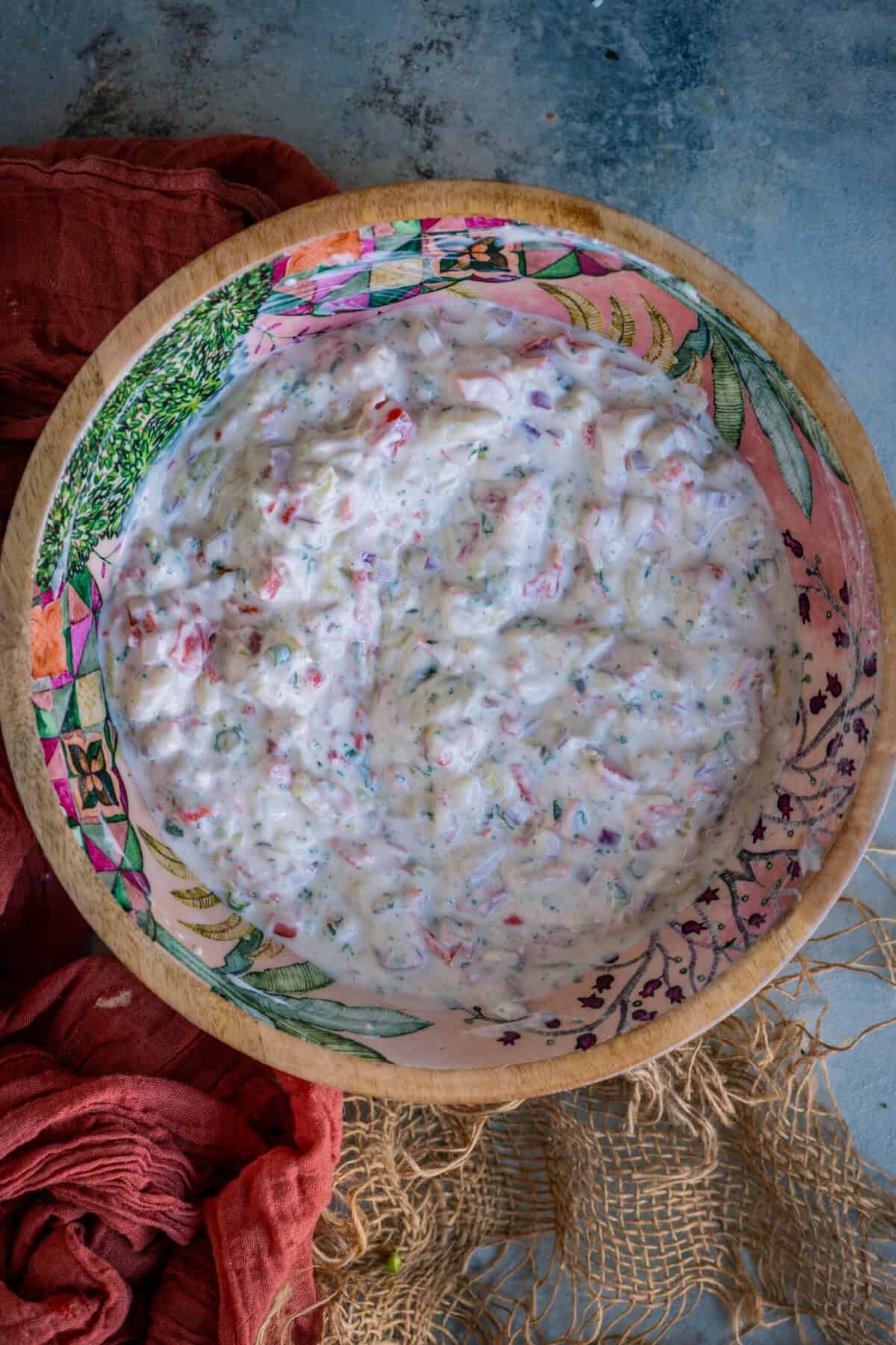 Finished koshimbir yogurt salad garnished with cilantro, served chilled.