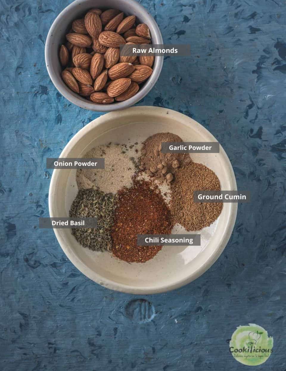 all the ingredients needed to make Smoky Spicy Garlic Roasted Almonds placed on a table with labels on them