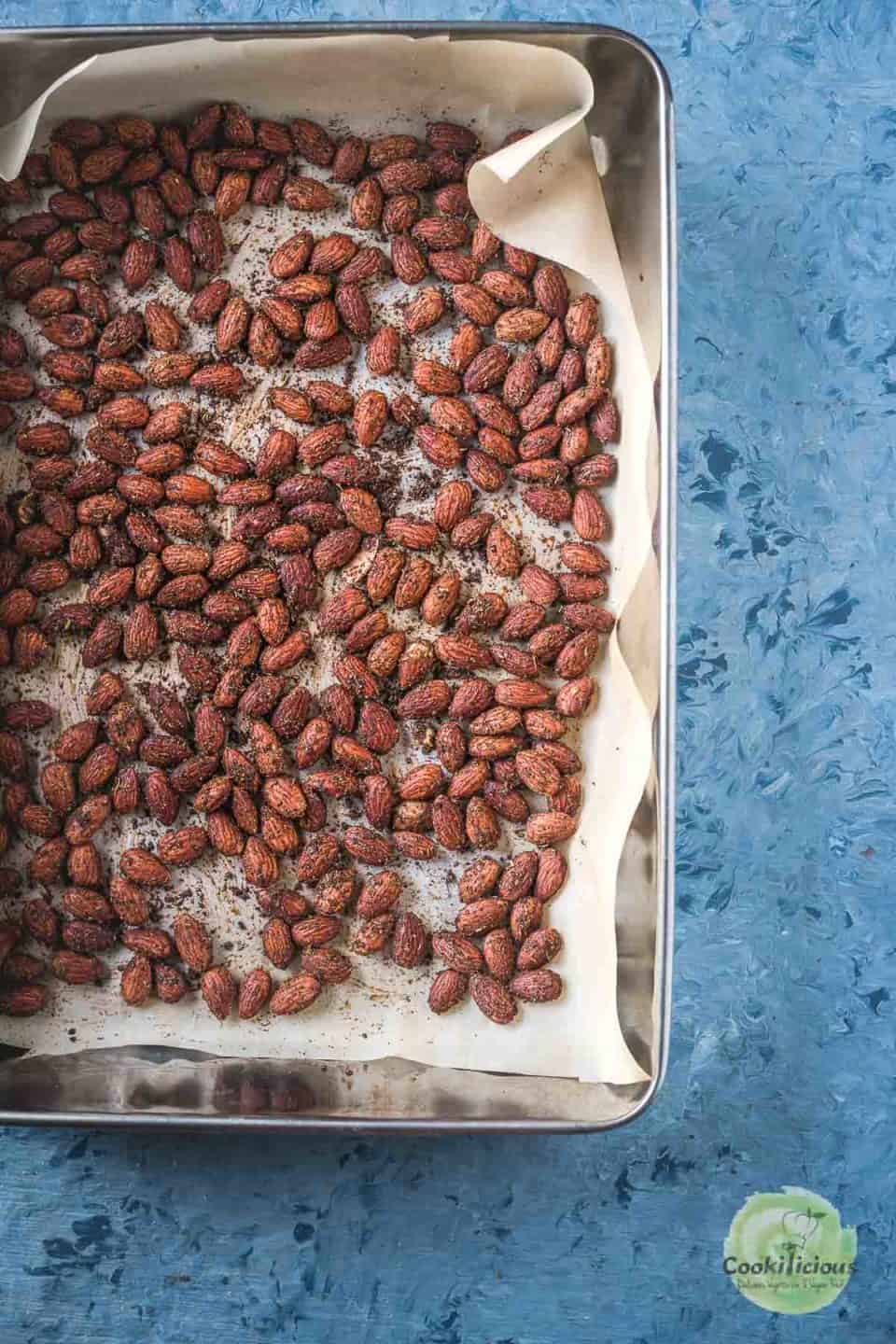 Smoky Spicy Garlic Roasted Almonds on a tray freshly out of the oven