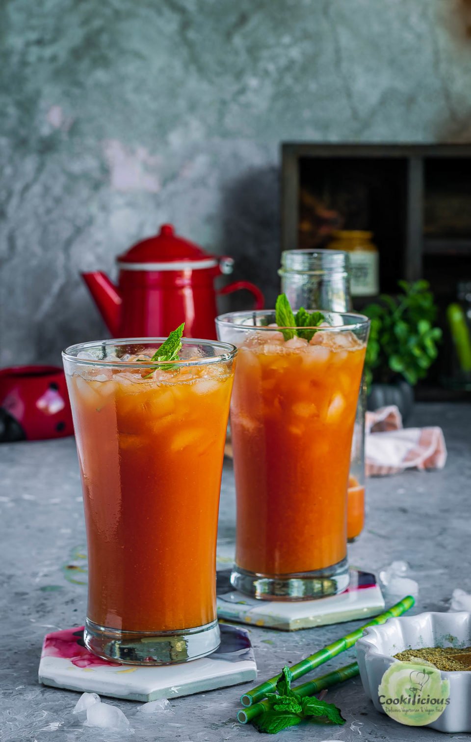 2 glasses of watermelon juice recipe - Sugar Free Drink placed over coasters and garnished with mint leaves