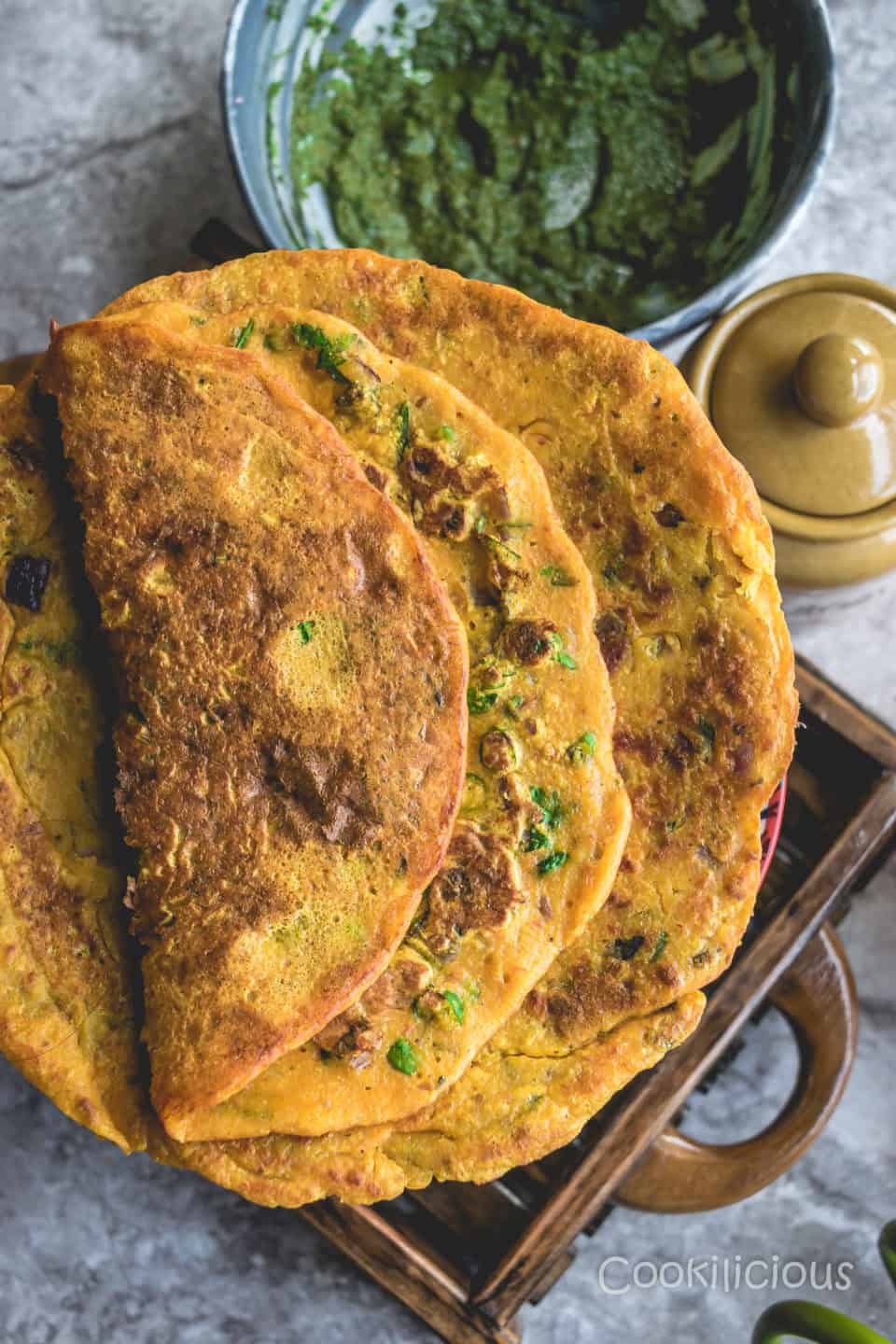 2 tomato omelette with chutney in the background