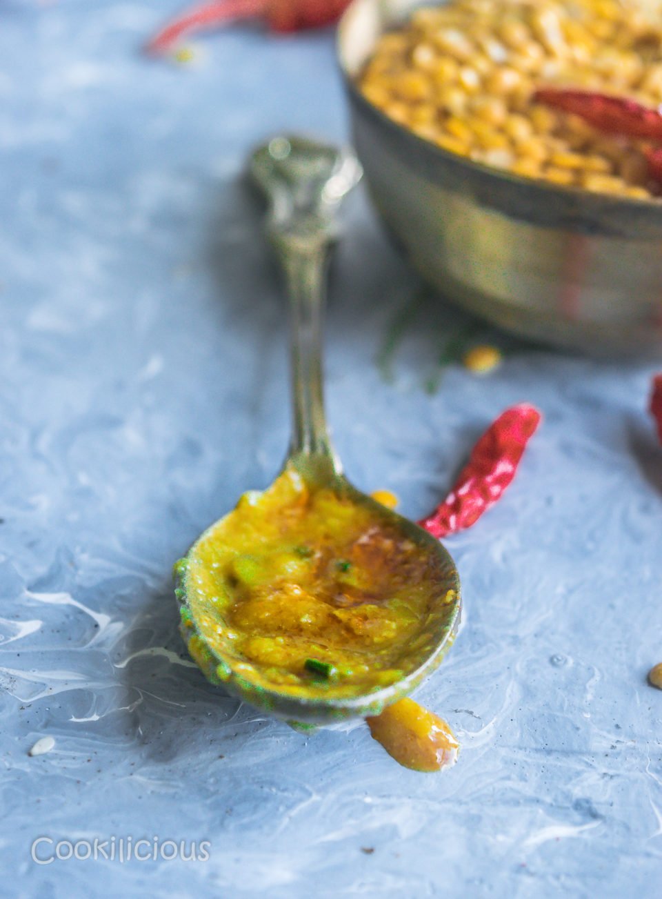 close up shot if a spoon smeared with Malvani Style Tikhat Dal