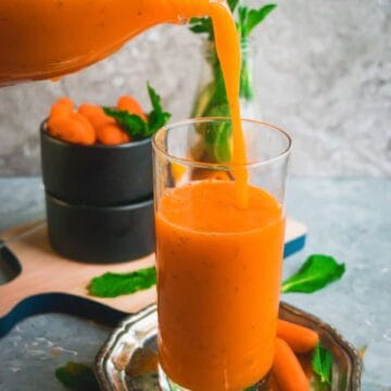 a bottle pouring Immune Boosting Sunshine Smoothie into a glass