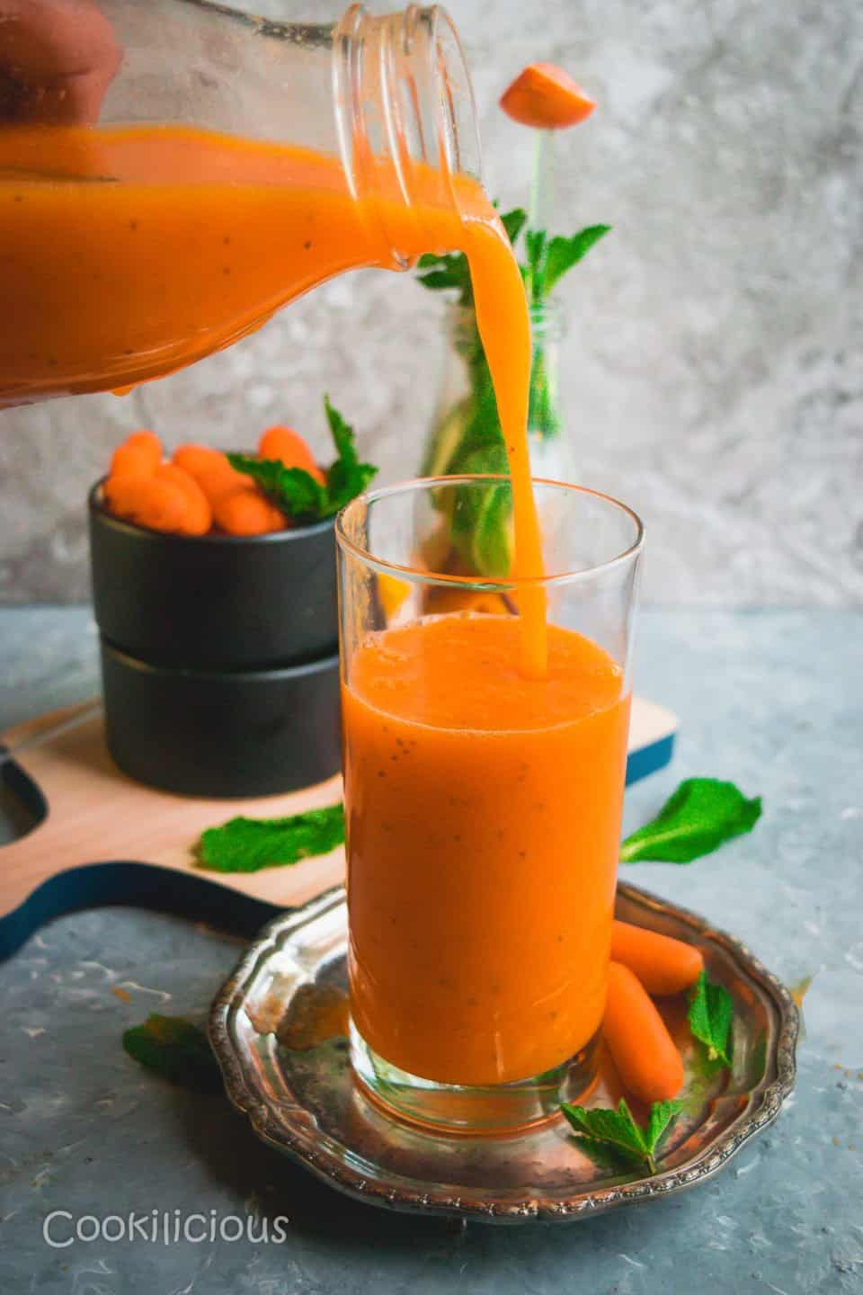 a bottle pouring Immune Boosting Sunshine Smoothie into a glass