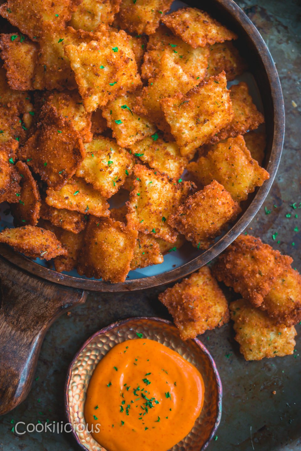 Copycat Olive Garden Cheesy Fried Ravioli in a tray with a dip on the side