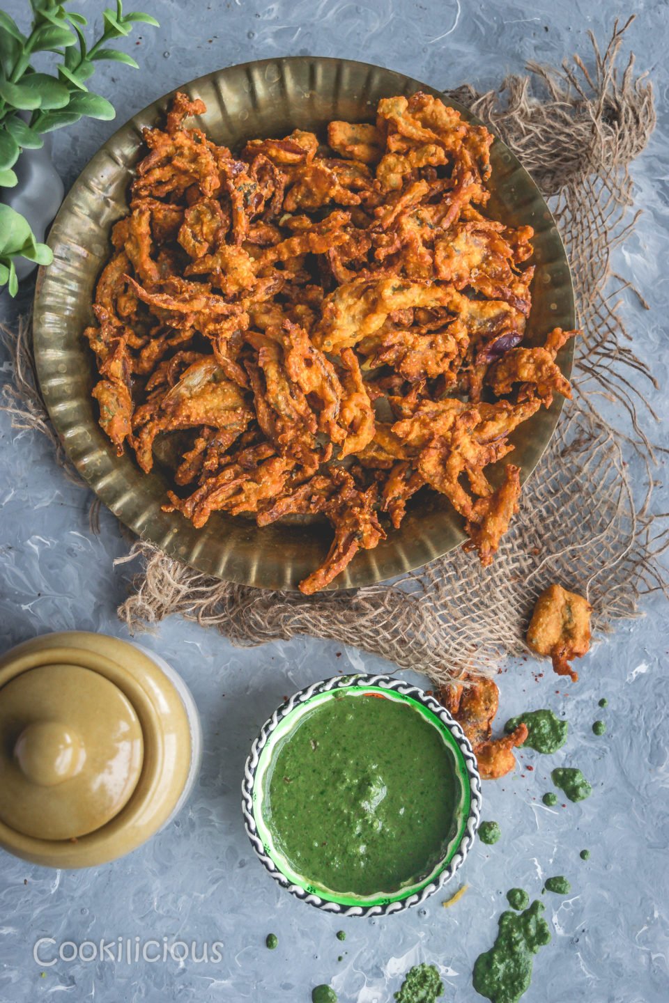 a plate filled with Vegan Crispy Onion Pakoda | Fried Kanda Bhajiya with chutney on the side