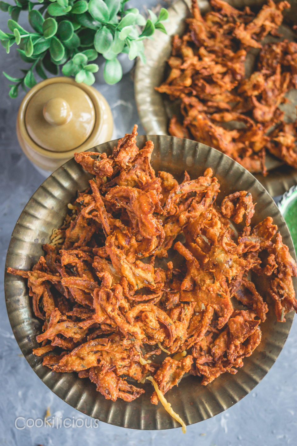 top angle shot of a plate filled with Vegan Crispy Onion Pakoda | Fried Kanda Bhajiya