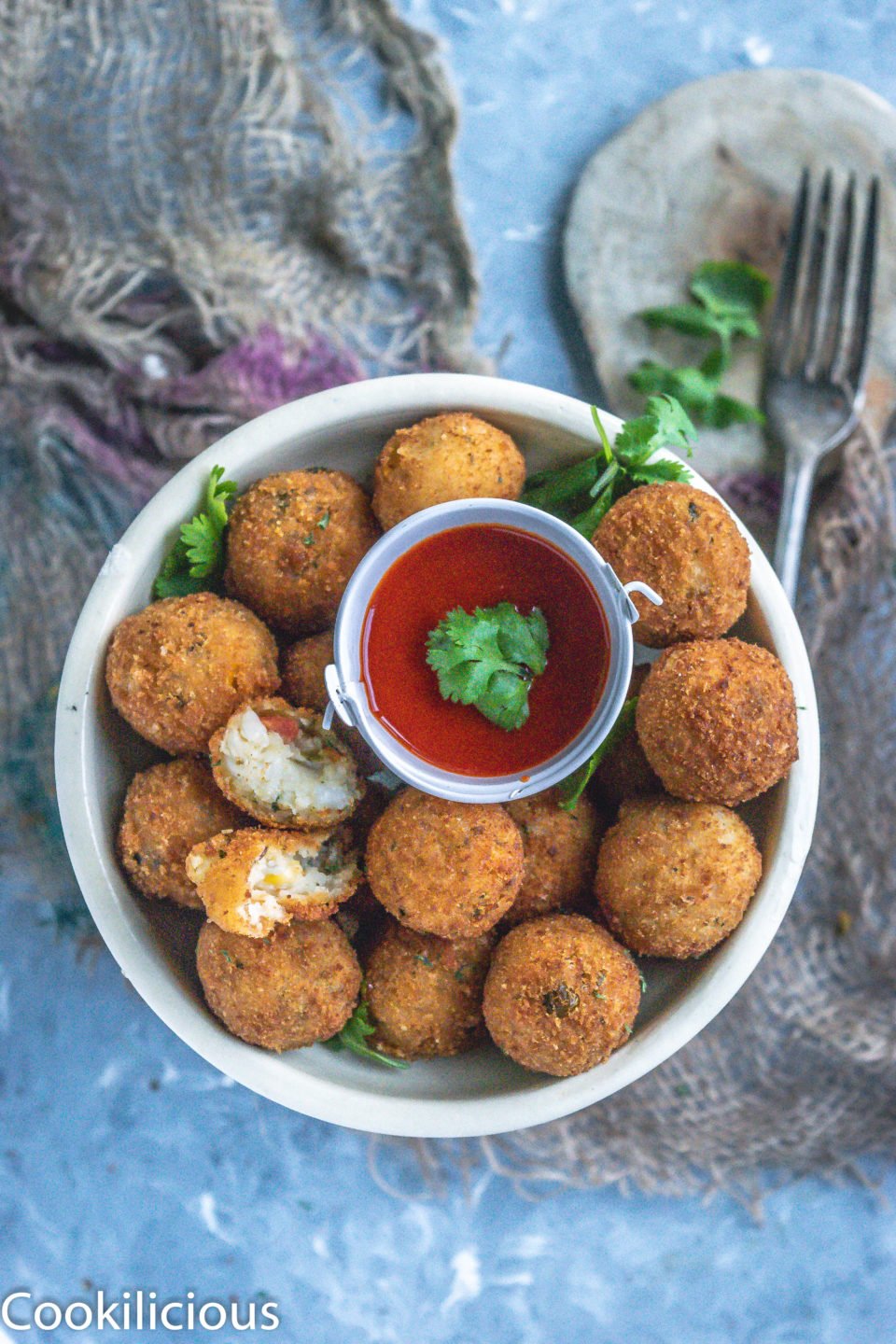 Semolina Vegetable Bites in a plate with a bowl of ketchup in the middle