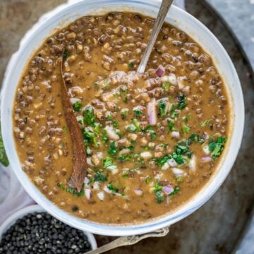 a spoon in a bowl of Black Lentils Stew | Kali Dal | Maa Ki Daal