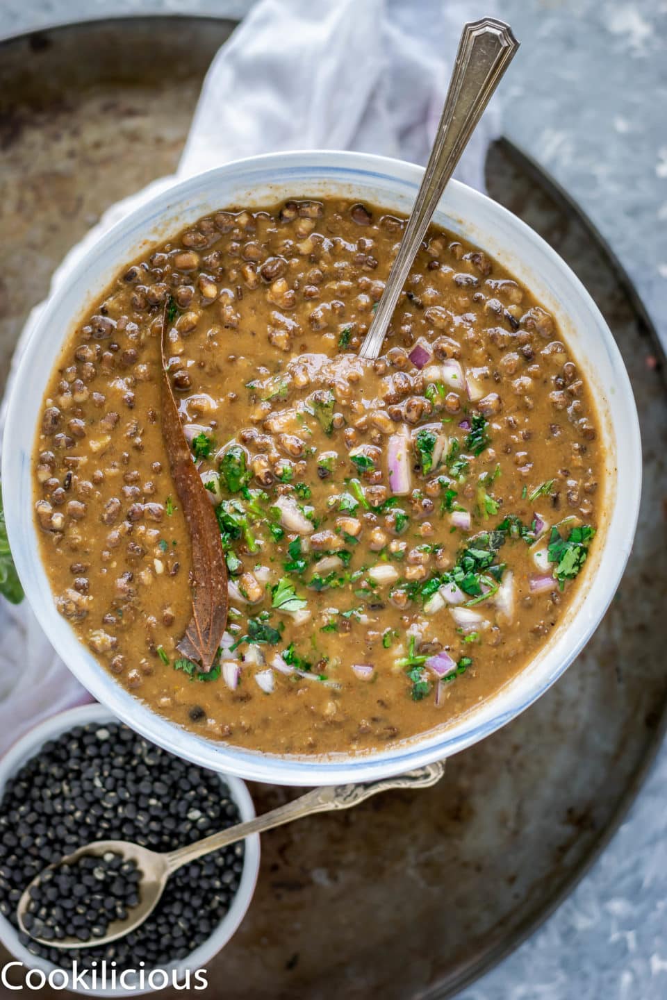a spoon in a bowl of Black Lentils Stew | Kali Dal | Maa Ki Daal