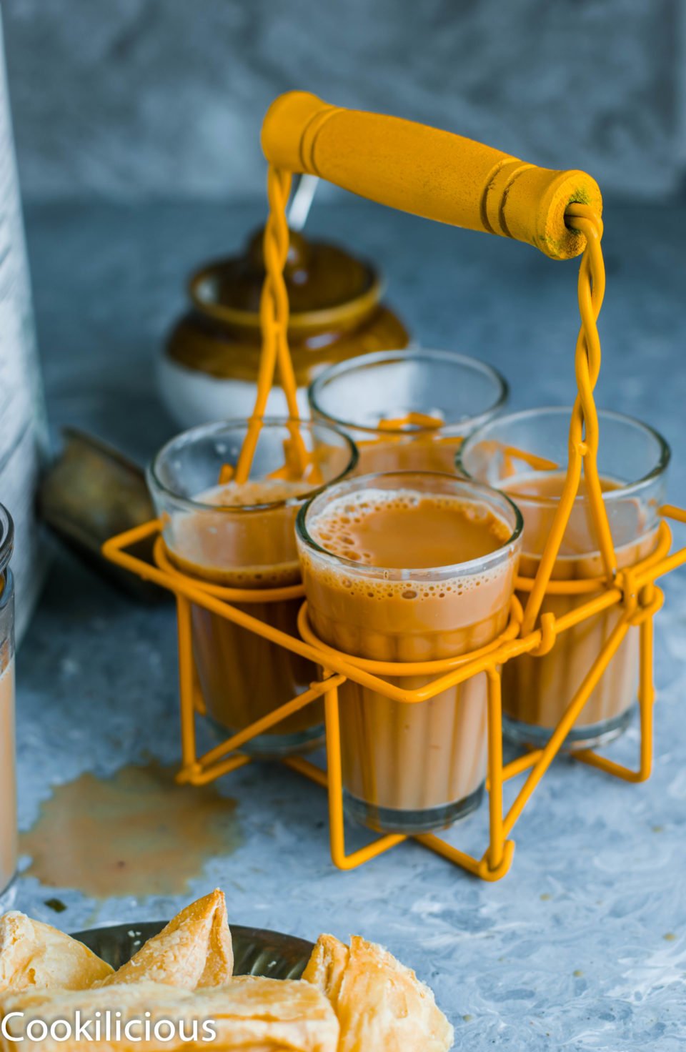 4 cups of masala chai resting in a chai stand