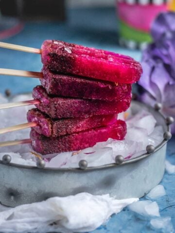 Masala Soda Blueberry Popsicles placed one on top of the other