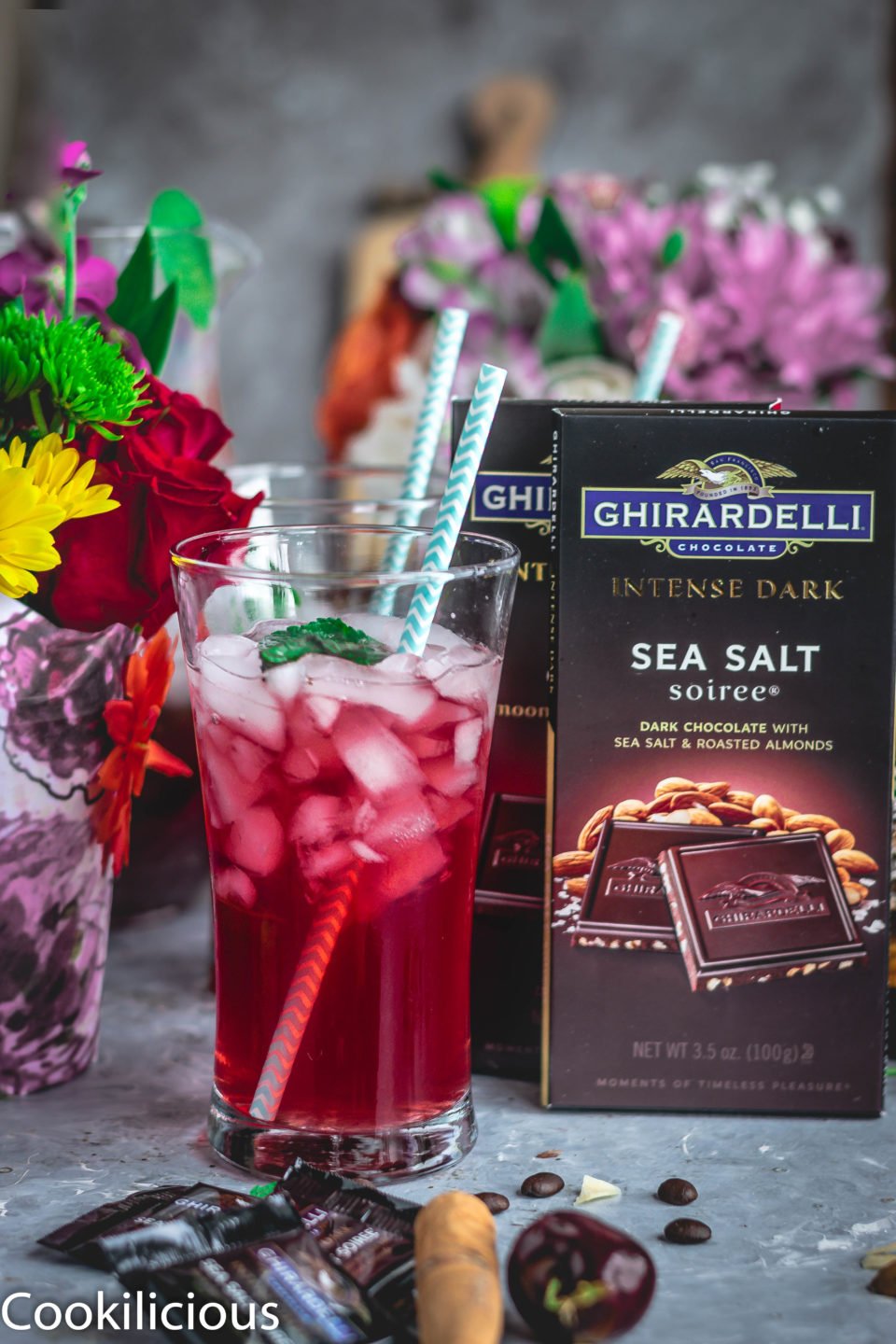 a glass of Cherry Lemon Iced Tea with a straw in it and Ghirardelli dark chocolate on the side
