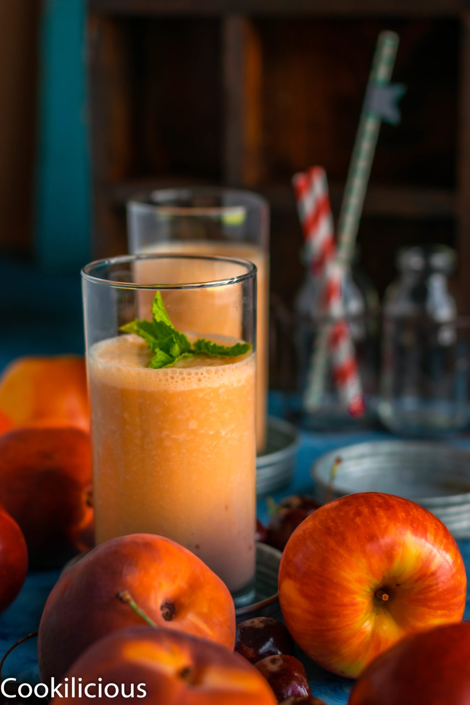 Peach & Raspberry Creamsicle Vegan Smoothie with apples and peaches in the front