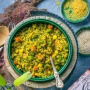 Vegetable Quinoa Upma in a bowl with a spoon in it