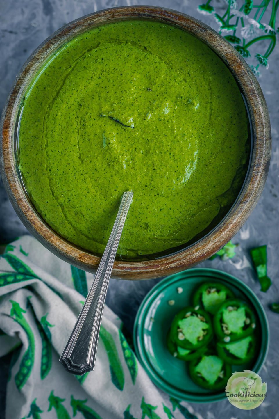 Mint Cilantro Chutney in a round bowl with a spoon in it
