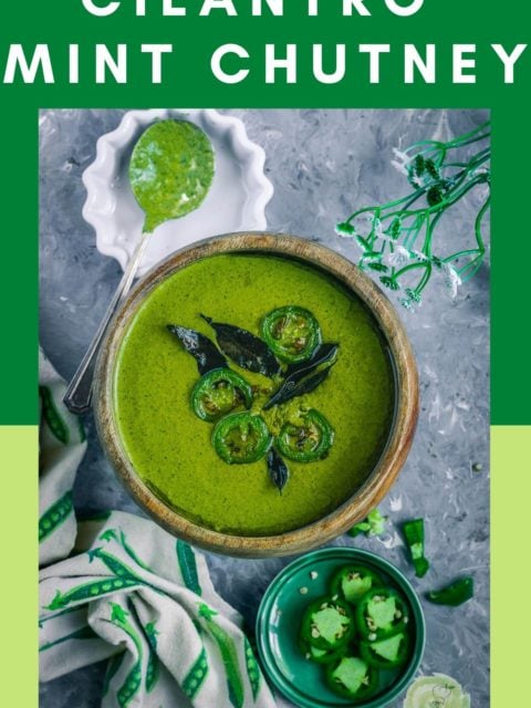 Mint Cilantro Chutney in a round bowl with sliced jalapenos on the side and a kitchen towel next to it and text at the top