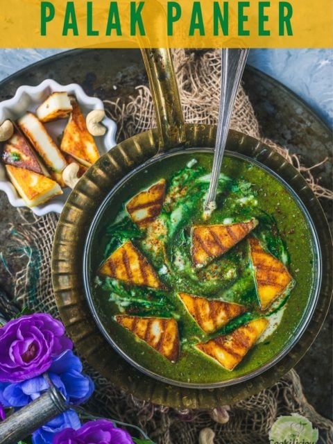 Restaurant Style Palak Paneer in a round platter with a spoon in it and some grilled paneer on the side and text at the top