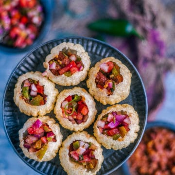 close up shot of Indian Mexican Pani Puri arranged in a round plate