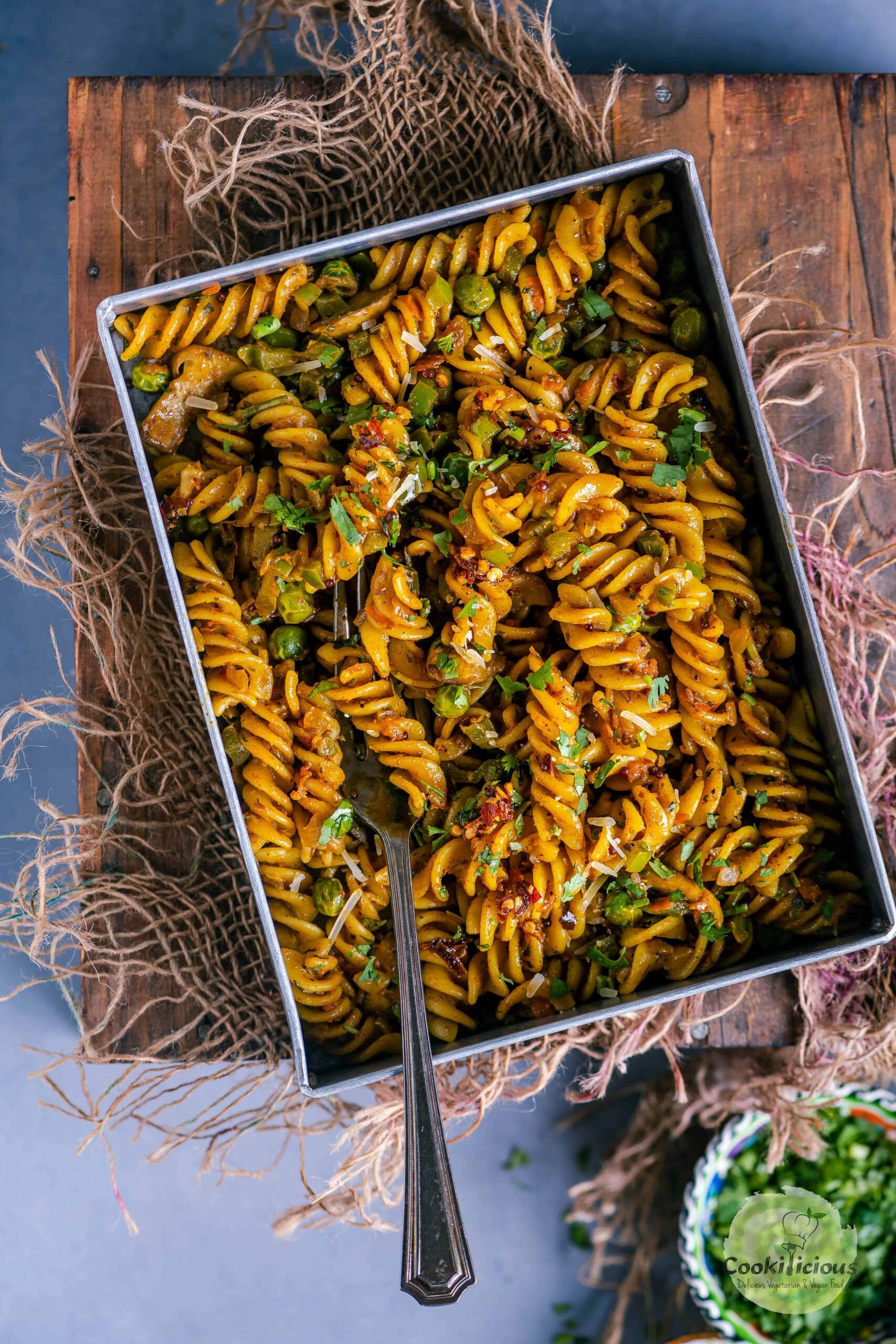 a rectangle tray filled with Indian curry pasta.