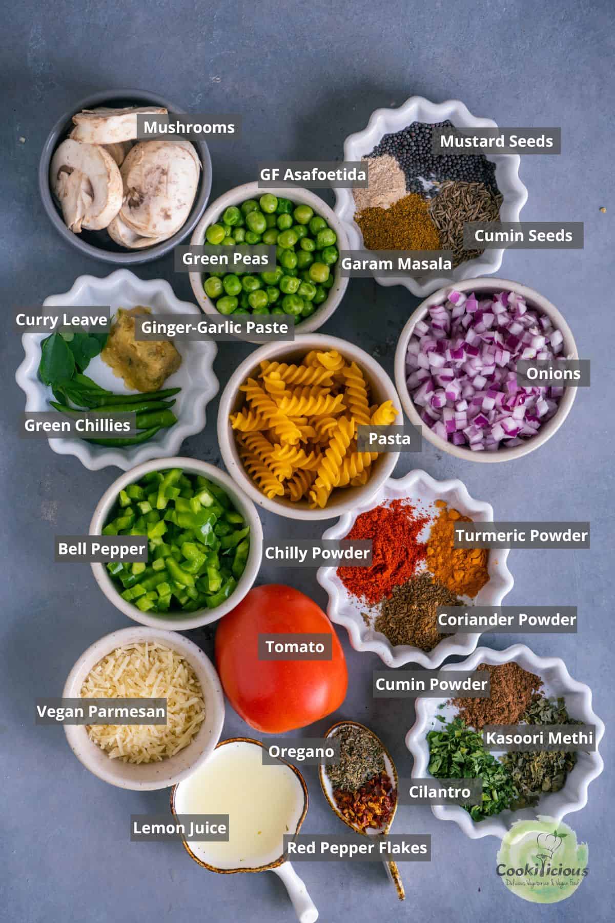 all the ingredients needed to make Indian masala pasta placed on a table with labels on them.