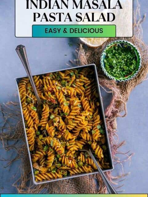 Desi Masala Pasta served in a rectangular tray with 2 forks in it and text at the top and bottom.