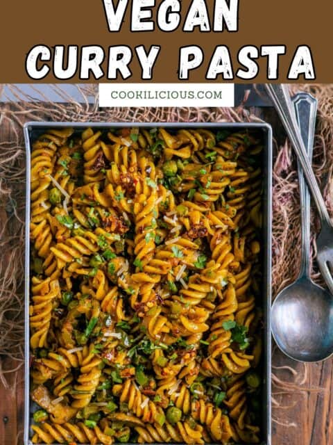 Indian masala curry pasta in a serving dish with a spoon and fork on the side and text at the top.
