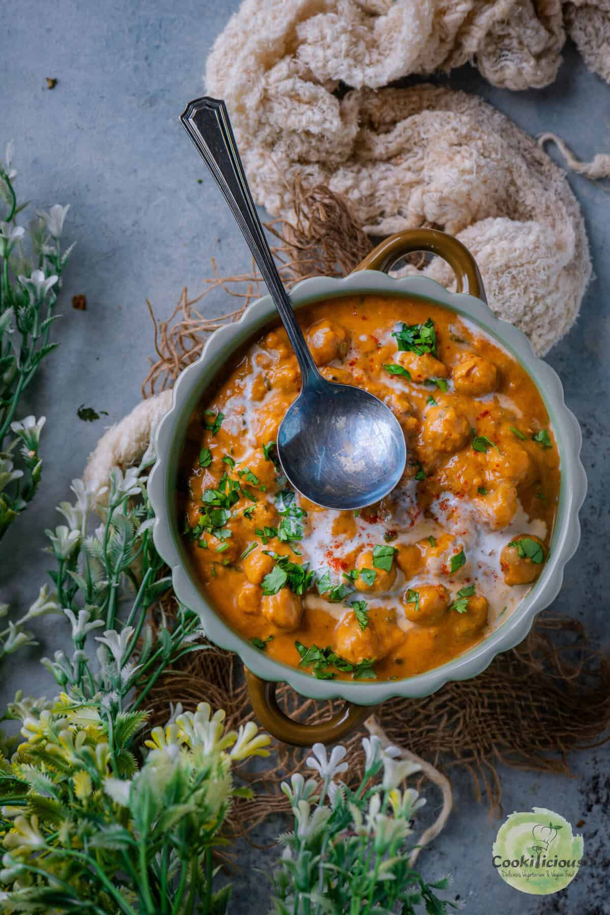 Bowl of creamy Instant Pot Vegan Sweet Potato Curry with Chickpeas, topped with fresh cilantro.