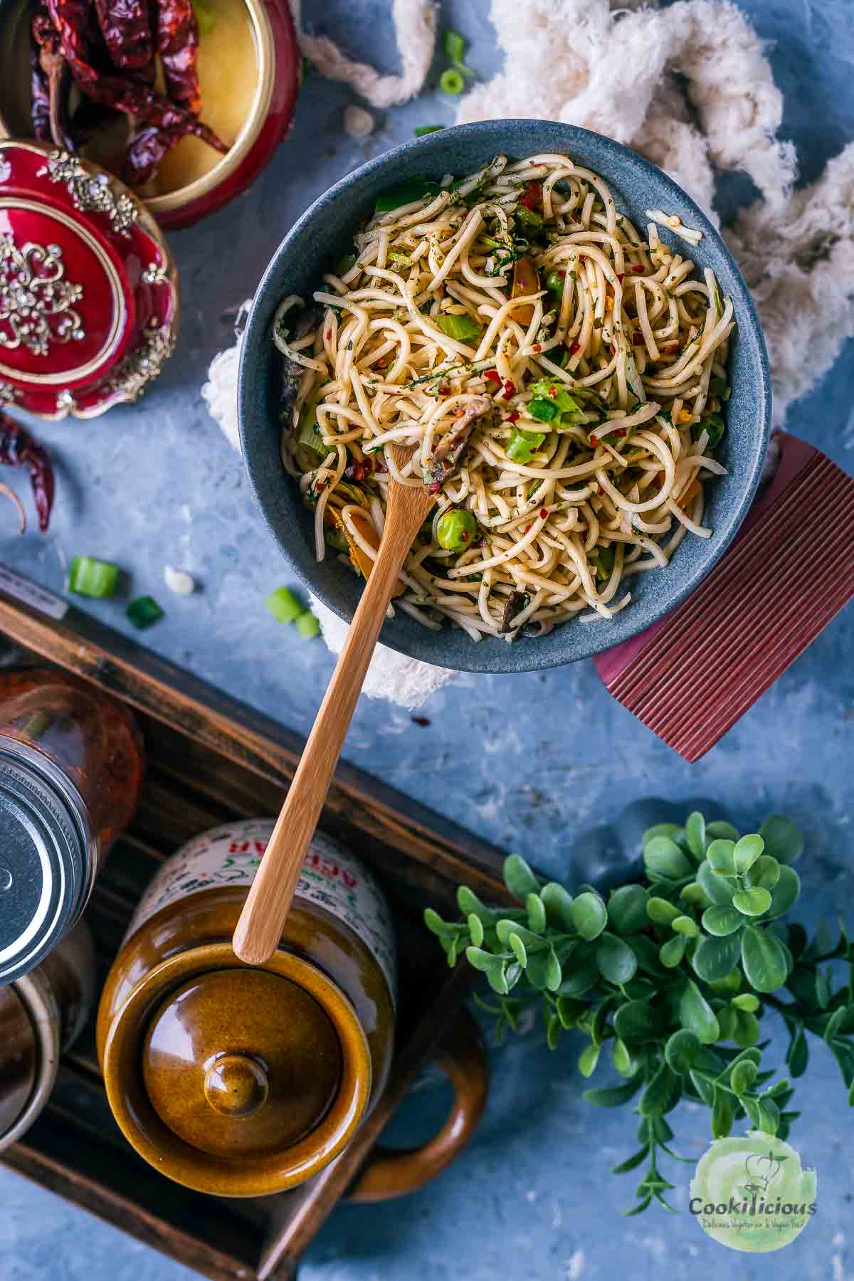 Hot and Spicy Noodles/ Cilantro Pot Noodles in a bowl with a fork in it and a jar on the side