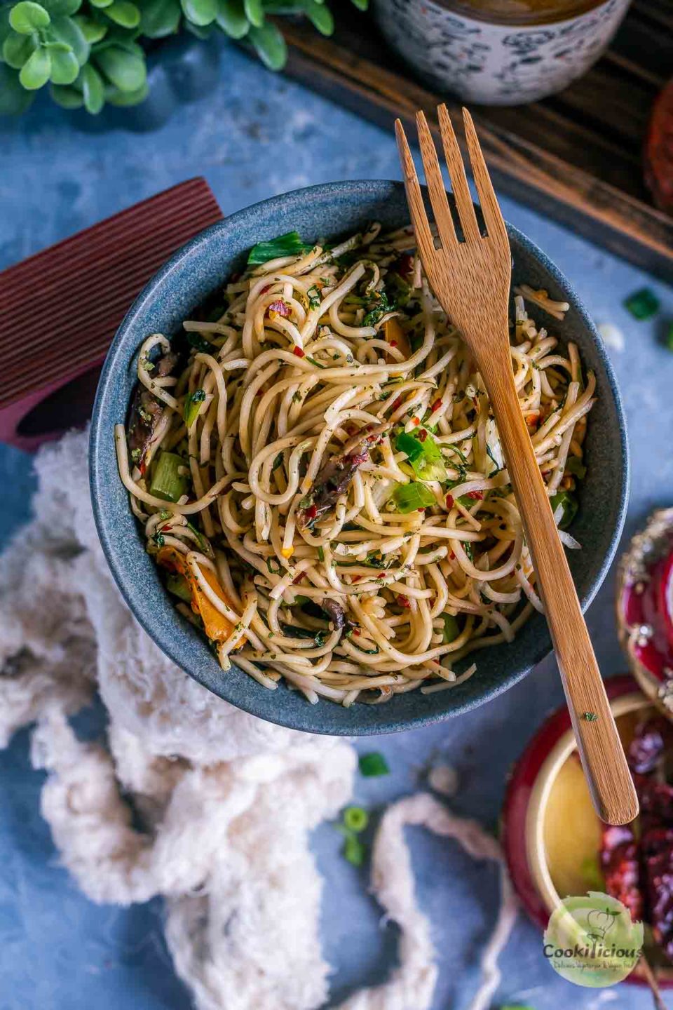 a bowl of Hot and Spicy Noodles/ Cilantro Pot Noodles with a fork resting on top