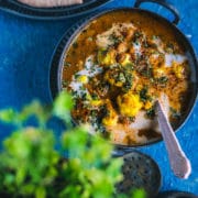 Cauliflower Tikka Masala - Easy Vegan Curry served in a small kadai with a spoon in it