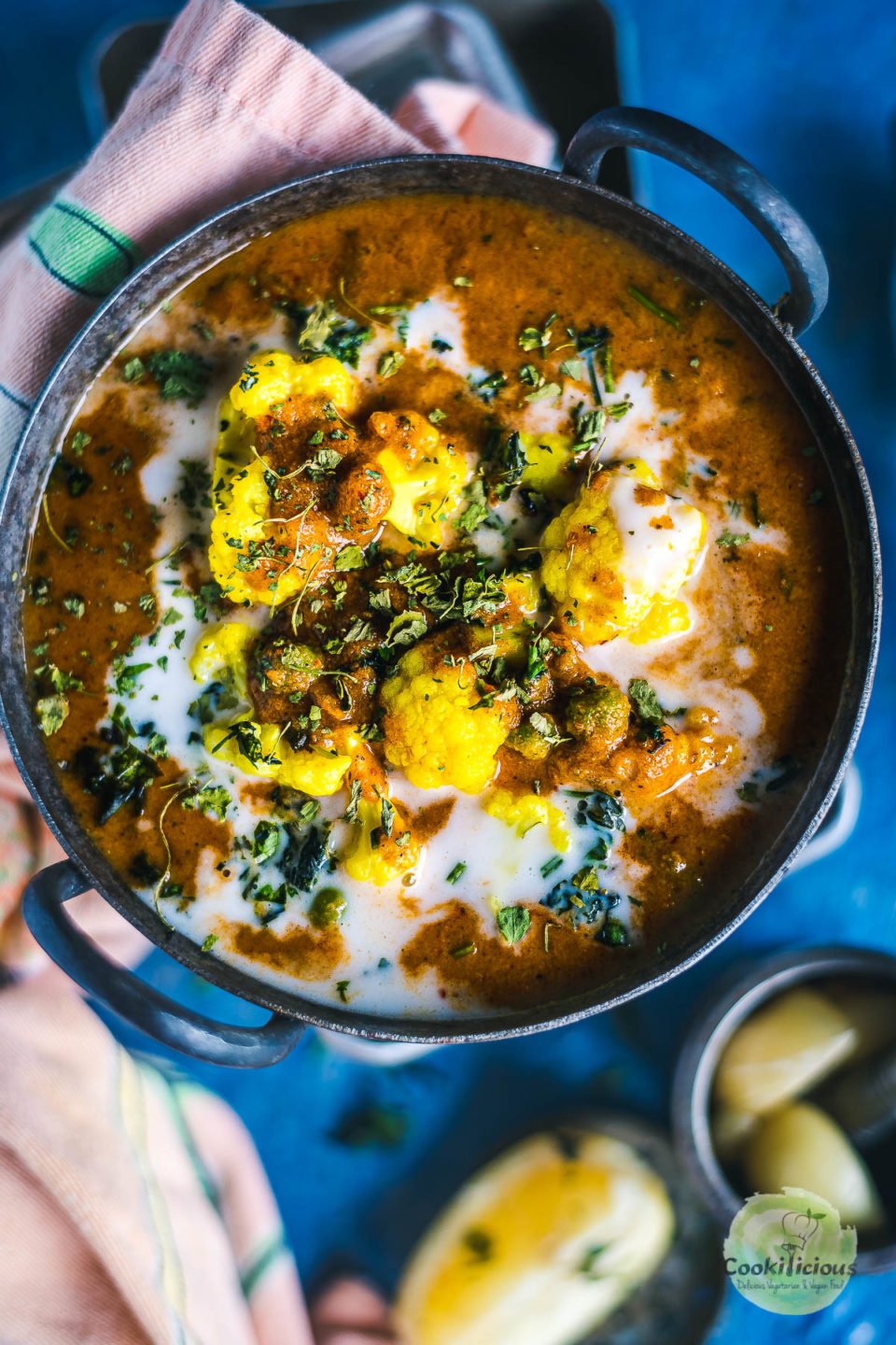 a small round kadai filled with Cauliflower Tikka Masala - Easy Vegan Curry