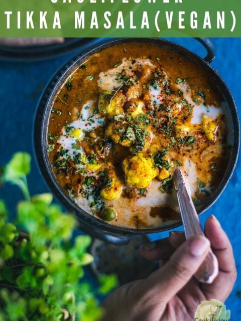 a hand putting a spoon into a small kadai of Cauliflower Tikka Masala - Easy Vegan Curry and text at the top