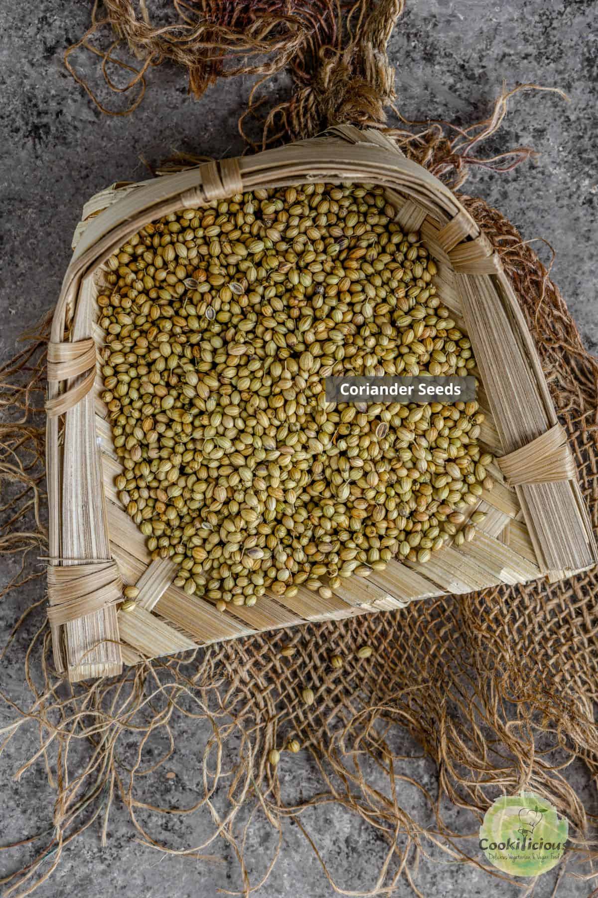Tray filled with whole coriander seeds ready to be dry roasted for making coriander powder.