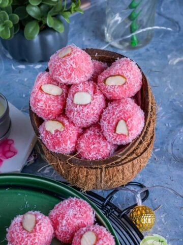 rose coconut ladoos served in coconut shells