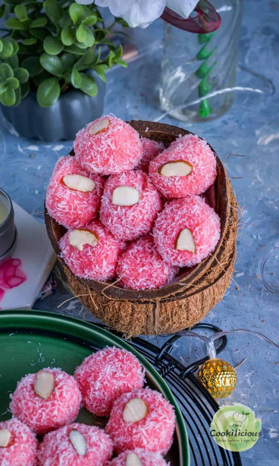 rose coconut ladoos served in coconut shells