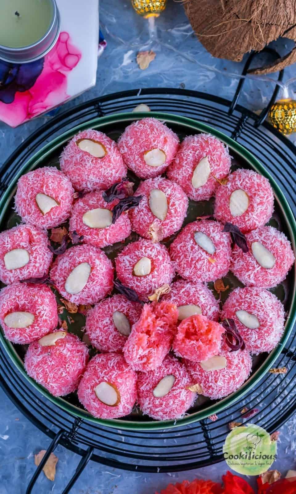 a round platter filled with coconut rose ladoos