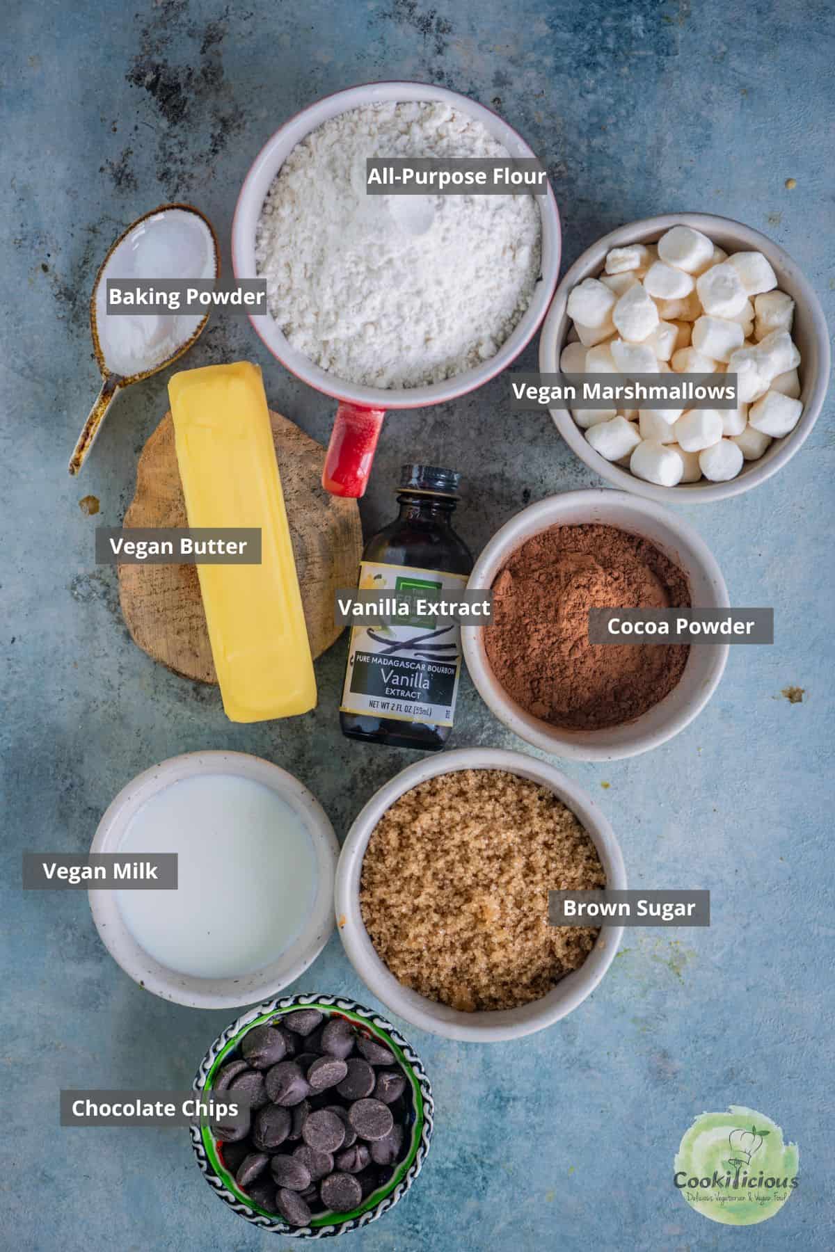 all the ingredients needed to make chocolate chip cookies with marshmallows placed on a table with labels on them.