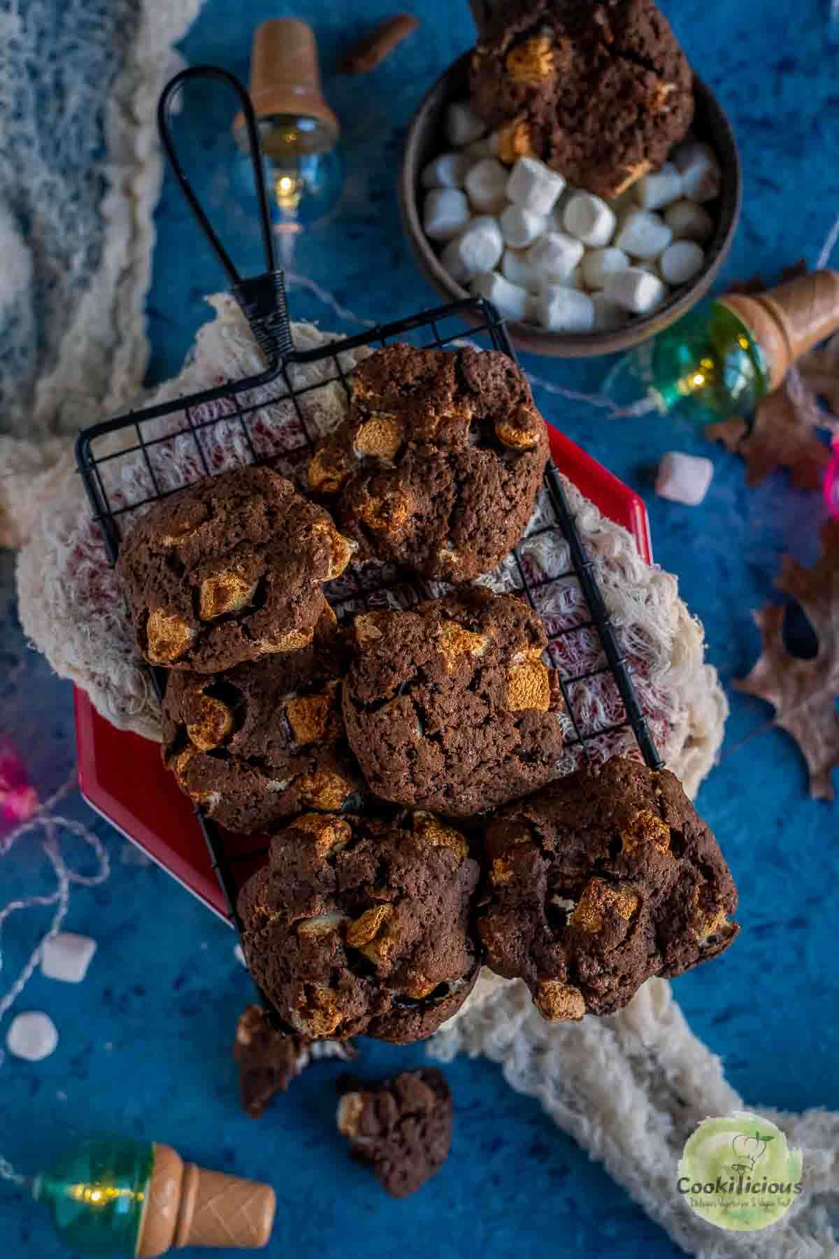 Vegan Marshmallow Chocolate Cookies placed over a wire rack with festive decor around it