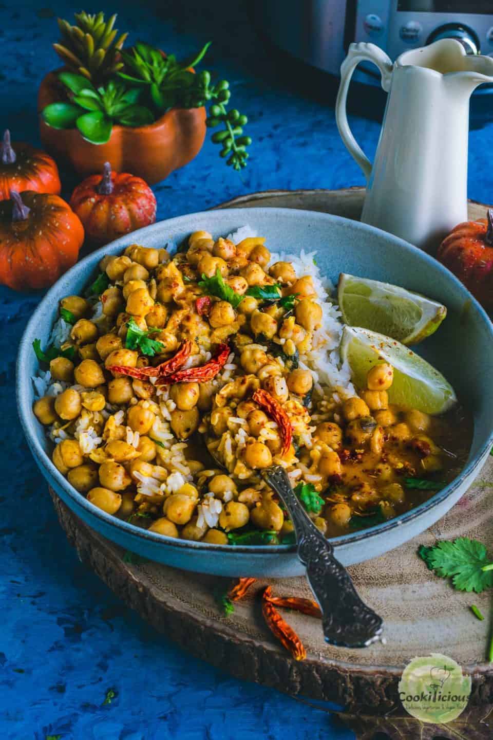 Instant Pot Butternut Squash Chickpea vegan Thai Curry served in a bowl with lemon wedges on the side