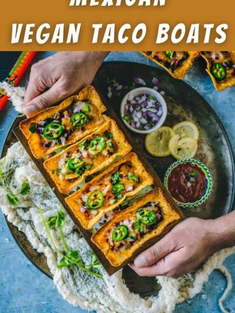 a set of hands serving a platter filled with Instant Pot Black Beans Taco Boats and text at the top and bottom