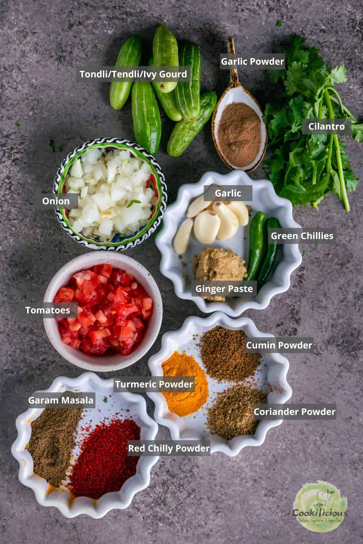 All the ingredients needed to make Tondli chi bhaji placed on a table with labels on them.